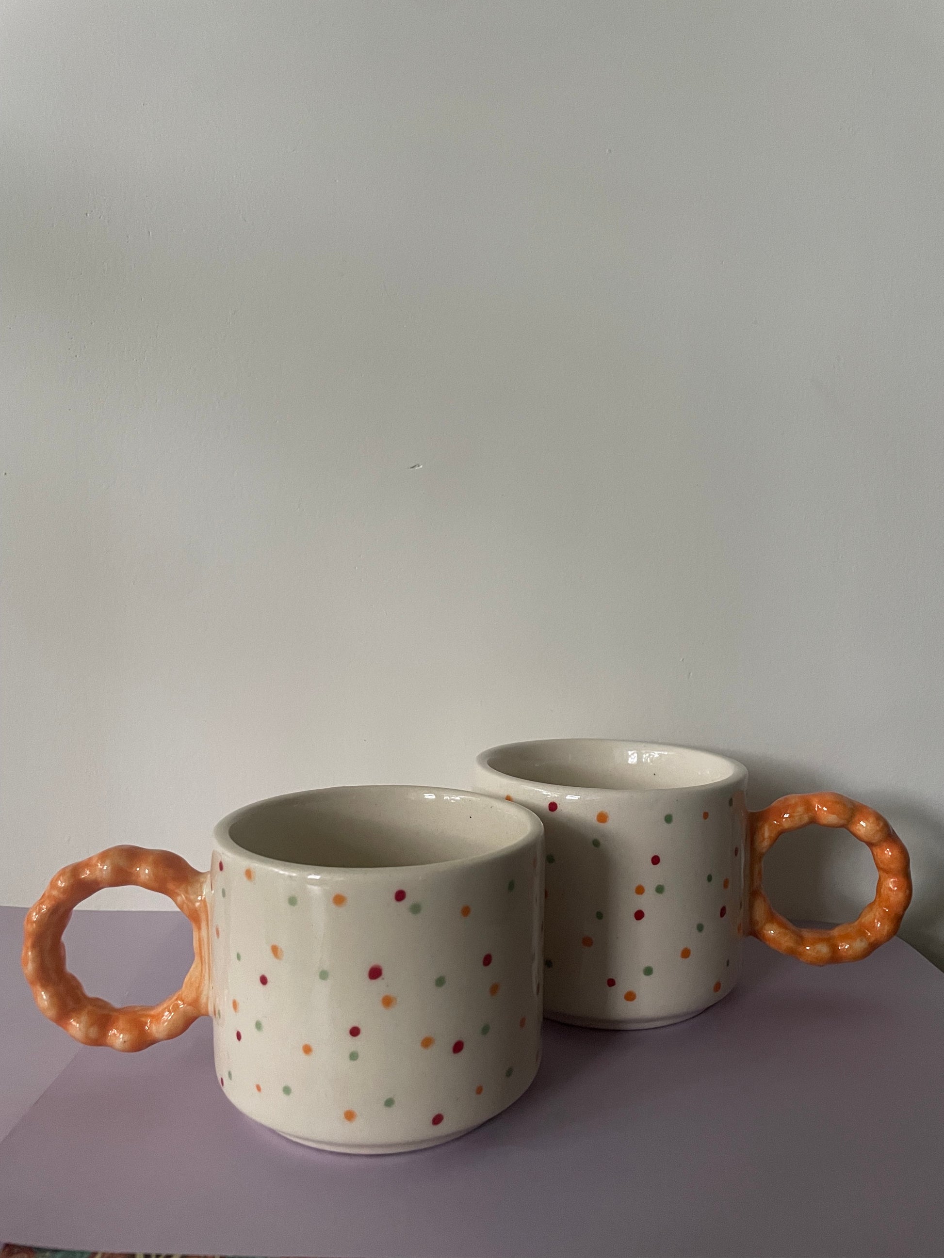 2 medium hand painted multicolor polka dot ceramic mugs, big round yellow bracelet handle. Buy affordable ceramic Bangalore