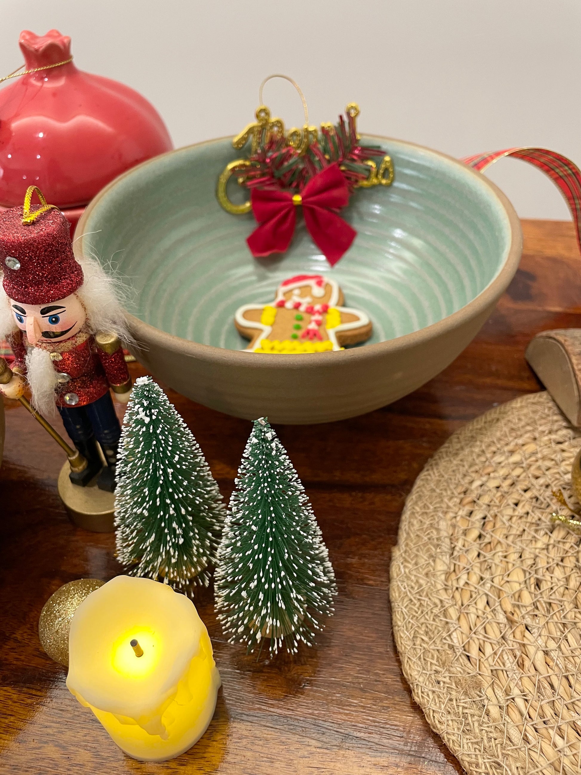 A stoneware finish large ceramic bowl in a Christmas setup with a cookie inside. Buy handmade bowls in India.